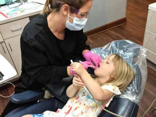 Child with Hygienist at Apex Dental Group in Apex, NC