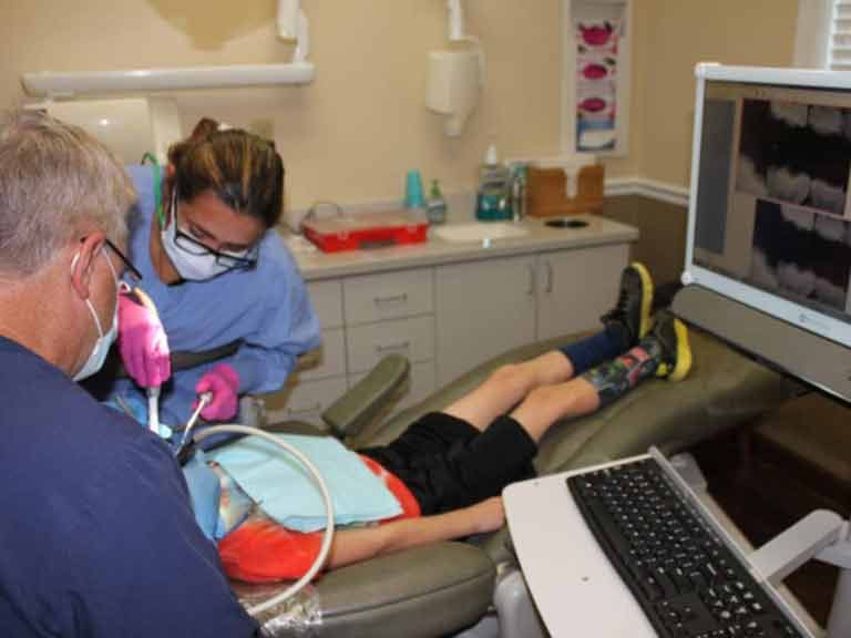 Child having tooth restoration and chair-side computer in Apex NC Child having tooth restoration and chair-side computer in Apex NC